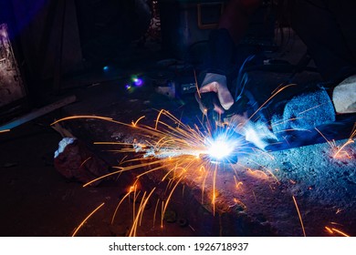 Industrial Workers At A Close-up Welding Plant