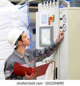 industrial workers inspect the technology of a plant for function - assembler in working clothes 