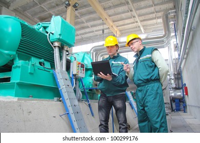 Industrial Workers With Notebook Working In Power Plant, Teamwork