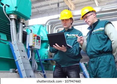 Industrial Workers With Notebook Working In A Power Plant, Teamwork