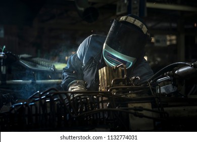 Industrial workers are welding steel parts automotive.