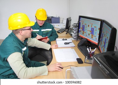 Industrial Workers Working In A Control Room