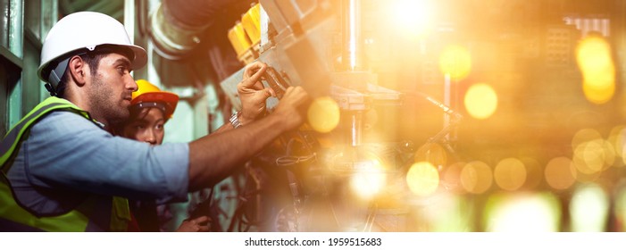 Industrial workers are working in the factory. Machine engineers or mechanical technicians and assistants are helping to repair and inspect the machine's readiness before the product is manufactured. - Shutterstock ID 1959515683