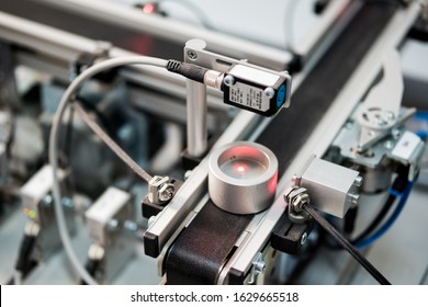 Industry 4.0 concept; artificial intelligence in smart factory. Close-up of product which is on Smart factory assembly line equipped with sensors and pneumatic equipments. 	 - Shutterstock ID 1629665518