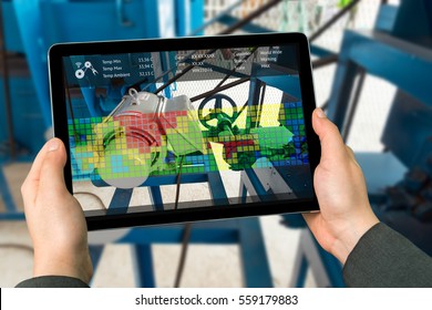 Industry 4.0 concept .Man hand holding tablet with Augmented reality screen software for measure temperature of motor in smart farm background