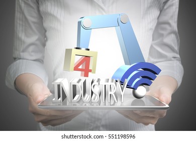 Industry 4.0 concept. Woman hand holding smart tablet to control 3D robot arm with wifi sign and text of industry 4.0.