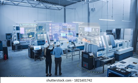 Industry 4.0 Factory: Two Engineers Uses Digital Tablet Computer with Augmented Reality Software to Connect with High-Tech Machinery, Robot Arm and Visualize Maintenance and Diagnostics of Equipment - Powered by Shutterstock