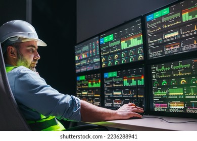 Industry 4.0. Head engineer control production line with computer screens. Factory operator following assembly process uses human-machine interface