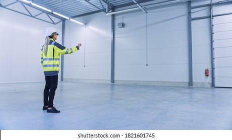 Industry 4.0 Modern Factory: Female Engineer Wearing Augmented Reality Headset Uses Mixed Reality Software And Gestures For Mapping Manufacturing Plant Floor For Future Machinery, Factory Floor Layout