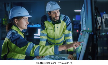 Industry 4.0 Modern Factory: Project Engineer Talks to Female Operator who Controls Facility Production Line, Uses Computer with Screens Showing AI, Machine Learning Enhanced Assembly Process - Shutterstock ID 1936528474