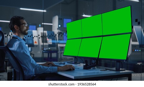 Industry 4.0 Modern Factory: Security Operator Controls Proper Functioning Of Workshop Production Line, Uses Computer With 6 Screens Showing Green Screen Mock Up Template.