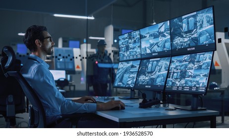 Industry 4.0 Modern Factory: Security Operator Controls Proper Functioning of Workshop Production Line, Uses Computer with Screens Showing Surveillance Camera Feed. High-Tech Security - Shutterstock ID 1936528570