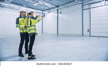 Industry 4.0 Modern Factory: Two Engineers Use Digital Tablet Computer with Augmented Reality Software Visualizing of Manufacturing Plant Room Mapping, Factory Layout. Illustrative Mock-up Concept