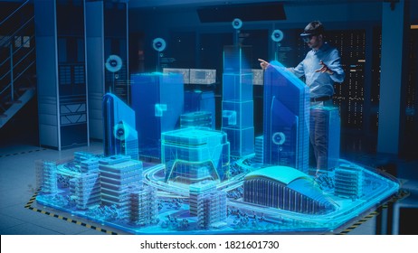 Industry 4.0: Modern Professional Architect Wearing Virtual Reality Headset Uses Gestures to Design, Manipulate Buildings for 3D City. Mixed Augmented Reality Software. VFX Graphics Effect - Powered by Shutterstock