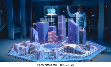 Industry 4.0: Modern Professional Architect Wearing Virtual Reality Headset Uses Gestures to Design, Manipulate Buildings for 3D City. Mixed Augmented Reality Software. VFX Special Visual Effect - Powered by Shutterstock