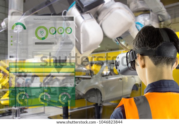 Industry 4.0 Robot concept .Engineers are using\
virtual AR to maintain and check the work of human robot in the 4.0\
Smart Factory.