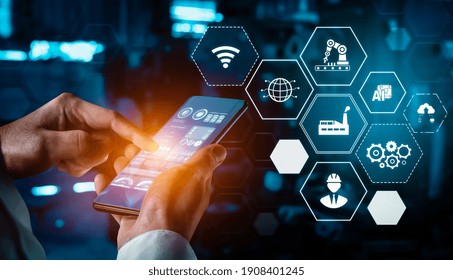Industry 4.0 technology concept - Smart factory for fourth industrial revolution with icon graphic showing automation system by using robots and automated machinery controlled via internet network .