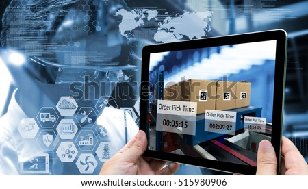 Industry 4.0,Augmented reality and smart logistic concept. Hand holding tablet with AR application for check order pick time in smart factory warehouse.Man use AR glasses and infographic background.