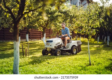 Industry Details - Portrait Of Gardener Smiling And Mowing Lawn, Cutting Grass In Garden