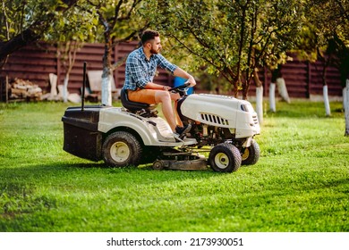 Industry Details - Portrait Of Gardener Smiling And Mowing Lawn, Cutting Grass In Garden