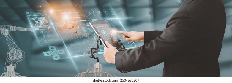 Industry engineer in factory,using smart tablet glass device,control automated robot arm machine learning operation,concept business and industry 4.0,Artificial intelligence or AI,with 5G network