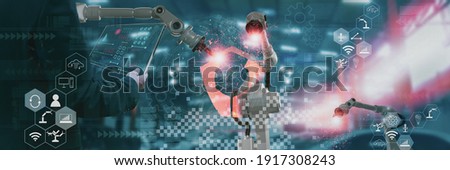 Industry engineer in factory,using smart tablet glass device,control automated robot arm machine learning operation,concept business and industry 4.0,Artificial intelligence or AI,with 5G network