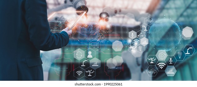 Industry engineer manager in factory,using smart tablet glass device,control automated robot arm machine learning operation,concept business,industry 4.0,Artificial intelligence or AI,with 5G network