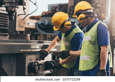 Industry engineer team worker teaching help talking production machine and setting it for work in modern factory. staff operate control heavy machine in factory - Powered by Shutterstock