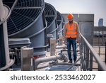 Industry engineer under checking the industry cooling tower air conditioner is water cooling tower air chiller HVAC of large industrial building to control air system.