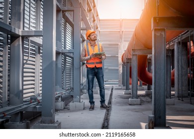 Industry engineer under checking the industry cooling tower air conditioner is water cooling tower air chiller HVAC of large industrial building to control air system. - Shutterstock ID 2119165658