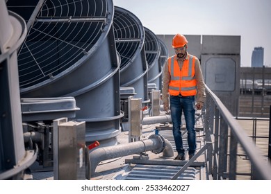 Industry engineer under checking the industry cooling tower air conditioner is water cooling tower air chiller HVAC of large industrial building to control air system.