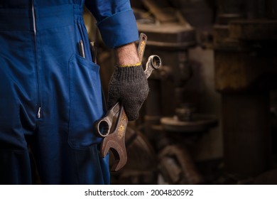 Industrietechnik trägt Sicherheitsvergleich und Handschuhschlüssel auf der Bedienmaschinenarbeit in der Industrie.