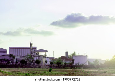 Industry Factory Buidling With Modern Warehouse In Sunset Sky Clouds Background. Environmentally Friendly Manufacturing Plant Of New Technology Production Line