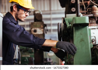 Industry Factory Maintenance Engineer Wearing Uniform And Safety Helmet Under Inspection And Checking Production Process On Factory Station On Machinery. Industry, Engineer, Construction Concept.