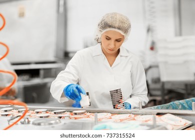 Industry, Food Production And People Concept - Woman Working At Ice Cream Factory Conveyor