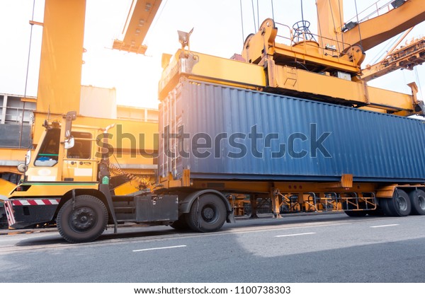 Industry\
logistics cargo operation concept of Grantry crane is delivery a\
40\'HC container on to the truck at\
port.
