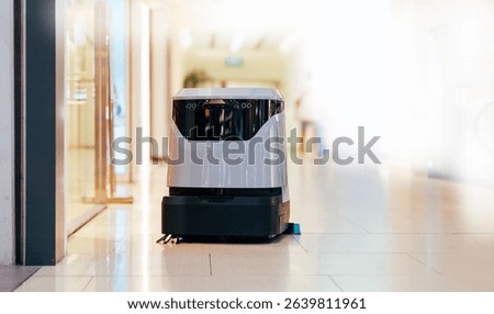 Industry machine with AI and camera. Automatic robot cleaner mopping of floor in commercial shop mall.
