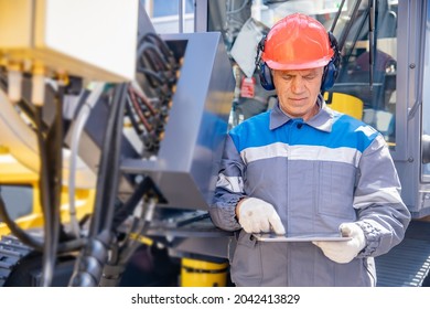 Industry Offshore Operator Use Mobile Tablet For Checking Drilling Rig For Exploration Of Minerals For Oil, Gas And Artisan Water.