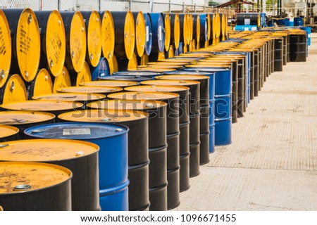 Industry oil barrels or chemical drums stacked up.container of  barrels of hydrocarbons.hazardous waste of black and blue tank oil.Stack Of Oil barrels in plant.