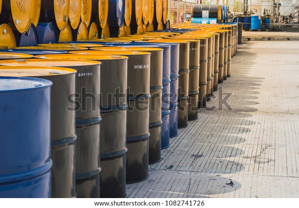 Industry oil barrels or chemical drums stacked\
up.chemical tank.container of  barrels of hydrocarbons.hazardous\
waste of black and blue tank\
oil.