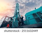 Industry operator use computer tablet for control drilling rig offshore. Technology in industrial exploration oil, minerals, gas and artisan water.