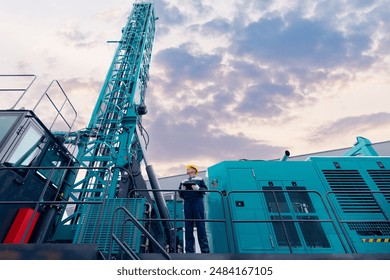 Industry operator use computer tablet for control drilling rig for exploration of minerals for oil, gas and artisan water.
