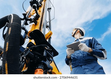 Industry operator use computer tablet for control drilling rig offshore. Technology in industrial exploration oil, minerals, gas and artisan water.