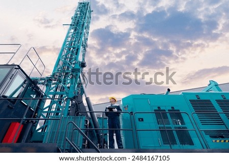 Industry operator use computer tablet for control drilling rig for exploration of minerals for oil, gas and artisan water.