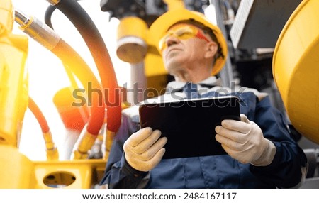 Industry operator use computer tablet for control drilling rig for exploration of minerals for oil, gas and artisan water.