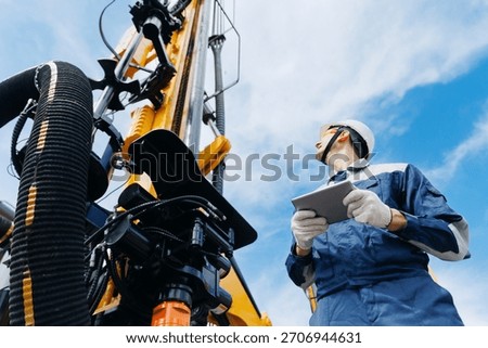 Industry operator use computer tablet for control drilling rig offshore. Technology in industrial exploration oil, minerals, gas and artisan water.