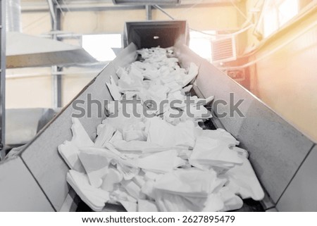 Industry Plant for sorting and processing plastic and paper waste. Conveyor assembly line with garbage bottles and packaging.