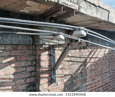 industry power wire through a wall with nonstandard insulator