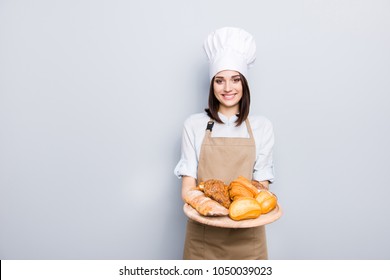 Industry prepare organic natural dough tasty fresh white clothes professional. Portrait of cheerful kind delightful baker demonstrating wooden tray with appetizing food isolated on gray background - Powered by Shutterstock