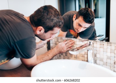 Industry Renovation Details. Construction Details With Handyman Or Worker Adding Mosaic Ceramic Tiles On Bathroom Walls